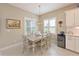 Dining room with a rustic table and chairs, light fixture, and shuttered windows at 12330 Halfmoon Lake Ter, Bradenton, FL 34211