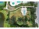 Overhead view of fenced dog park with agility equipment, near pool, tennis court, and pond at 12330 Halfmoon Lake Ter, Bradenton, FL 34211