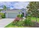 Charming single-story home featuring a well-maintained lawn, lush garden and a paved driveway at 12330 Halfmoon Lake Ter, Bradenton, FL 34211