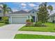Charming home with a well-manicured lawn, flowering shrubbery, and a two car garage at 12330 Halfmoon Lake Ter, Bradenton, FL 34211