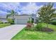 Charming single-story home with manicured landscaping, a two-car garage, and a paver driveway at 12330 Halfmoon Lake Ter, Bradenton, FL 34211