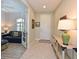 Foyer with tile flooring, console table, and view into living room with blue couch at 12330 Halfmoon Lake Ter, Bradenton, FL 34211