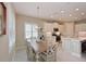 Bright kitchen with a dining table, stainless appliances, white cabinetry and tile floors at 12330 Halfmoon Lake Ter, Bradenton, FL 34211