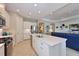 Bright open kitchen with island seating, stainless steel appliances, and views to the living room at 12330 Halfmoon Lake Ter, Bradenton, FL 34211