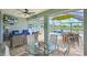 Screened-in lanai with outdoor seating, a ceiling fan, a tv and a view of the pool at 12330 Halfmoon Lake Ter, Bradenton, FL 34211