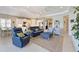 Open-concept living room with kitchen, tile floors, and comfortable seating at 12330 Halfmoon Lake Ter, Bradenton, FL 34211