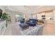 Open-concept living room with kitchen, tile floors, and comfortable seating at 12330 Halfmoon Lake Ter, Bradenton, FL 34211