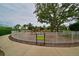 Fenced playground featuring play structures, mature trees, and walking path, designed for Gathering fun and recreation at 12330 Halfmoon Lake Ter, Bradenton, FL 34211