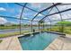 Beautiful screened-in pool with waterfall features overlooking a serene lake at 12330 Halfmoon Lake Ter, Bradenton, FL 34211