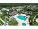 Aerial view of the neighborhood pool, cabana, seating areas, and verdant trees creating a private retreat at 12330 Halfmoon Lake Ter, Bradenton, FL 34211