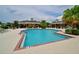 Gorgeous community pool highlighting the pristine pool, cabana, seating, and tropical greenery creating a resort-like atmosphere at 12330 Halfmoon Lake Ter, Bradenton, FL 34211