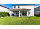 Spacious backyard with a covered patio, grill, and green lawn at 13422 Flat Woods Ter, Bradenton, FL 34211
