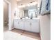 Bright bathroom with a dual sink vanity, framed mirror, and stylish fixtures at 13422 Flat Woods Ter, Bradenton, FL 34211