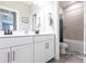 Bathroom featuring dual sinks, modern fixtures, and a shower-tub combo at 13422 Flat Woods Ter, Bradenton, FL 34211