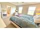 Bright bedroom with large windows, a cozy chair, and an ensuite bathroom view at 13422 Flat Woods Ter, Bradenton, FL 34211