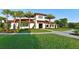 Inviting clubhouse exterior with lush landscaping, palm trees, and a well-maintained lawn at 13422 Flat Woods Ter, Bradenton, FL 34211