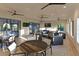 Comfortable clubhouse interior featuring tables, chairs, ceiling fans, and large windows with natural light at 13422 Flat Woods Ter, Bradenton, FL 34211