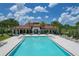Beautiful community pool with lounge chairs and tables for relaxing poolside under a sunny sky at 13422 Flat Woods Ter, Bradenton, FL 34211