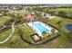 Aerial view of a community pool with a lounge area and well maintained lawn space at 13422 Flat Woods Ter, Bradenton, FL 34211