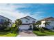 Exterior of home featuring a driveway, landscaping, and a two-car garage at 13422 Flat Woods Ter, Bradenton, FL 34211