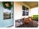 Inviting front porch featuring brick pavers and comfortable wooden chairs at 13422 Flat Woods Ter, Bradenton, FL 34211
