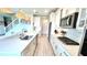 Stylish kitchen with white cabinets, subway tile backsplash, stainless appliances, and a central island at 13422 Flat Woods Ter, Bradenton, FL 34211