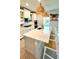 Close up of a modern kitchen island with seating, stylish lighting, and bright decor at 13422 Flat Woods Ter, Bradenton, FL 34211