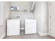 Functional laundry room with a washer, a dryer, and storage shelves at 13422 Flat Woods Ter, Bradenton, FL 34211