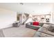 Bright, open-concept living area featuring a large sectional sofa and a staircase to the upper level at 13422 Flat Woods Ter, Bradenton, FL 34211