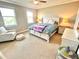 Comfortable bedroom with natural light, ceiling fan, a large window, and a sitting area at 13422 Flat Woods Ter, Bradenton, FL 34211