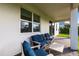 Comfortable covered patio with blue cushioned seating, perfect for outdoor relaxation at 13422 Flat Woods Ter, Bradenton, FL 34211