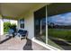 Covered patio with chairs overlooking the backyard and lake at 13422 Flat Woods Ter, Bradenton, FL 34211