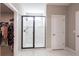 Modern shower with white tiled walls and a sleek black frame at 13422 Flat Woods Ter, Bradenton, FL 34211