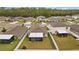 Aerial view of multiple roofs in a neighborhood featuring a pond and lush green trees on a sunny day at 13422 Willow Bluestar Loop, Riverview, FL 33579