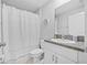 Clean bathroom featuring granite counters, a shower with curtain, and white fixtures at 13422 Willow Bluestar Loop, Riverview, FL 33579