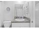 Well-lit bathroom with granite counters, white cabinets, and modern fixtures at 13422 Willow Bluestar Loop, Riverview, FL 33579