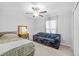 Inviting bedroom with a ceiling fan, ample natural light, and comfortable seating at 13422 Willow Bluestar Loop, Riverview, FL 33579