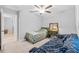 Bright bedroom with a ceiling fan, natural light, and cozy furnishings at 13422 Willow Bluestar Loop, Riverview, FL 33579