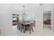 Dining room features a sliding glass door to the back patio and modern chandelier at 13422 Willow Bluestar Loop, Riverview, FL 33579