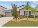 Charming single-story home with a manicured lawn, landscaping, and a welcoming front entrance at 13422 Willow Bluestar Loop, Riverview, FL 33579