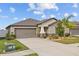 Charming single-story home with a two car garage and well maintained lawn at 13422 Willow Bluestar Loop, Riverview, FL 33579