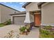 Beautiful single-Gathering home featuring a two-car garage and stone accents on the facade at 13422 Willow Bluestar Loop, Riverview, FL 33579