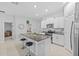 Stylish kitchen with a large island, granite countertops, and a pantry for storage at 13422 Willow Bluestar Loop, Riverview, FL 33579