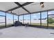 This screened lanai features concrete flooring, ceiling fans, string lights, and outdoor furniture and a grill at 13422 Willow Bluestar Loop, Riverview, FL 33579