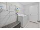 Laundry room features washer, dryer, storage shelving, and a seating bench at 13422 Willow Bluestar Loop, Riverview, FL 33579