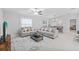Bright living room featuring tile floors, neutral walls, two couches and a center coffee table with decor at 13422 Willow Bluestar Loop, Riverview, FL 33579