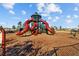 Vibrant playground with a towering red slide structure and a wood chip ground cover for safe and fun outdoor activity at 13422 Willow Bluestar Loop, Riverview, FL 33579