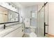 Modern bathroom featuring granite countertop vanity, framed mirror, elegant lighting, and glass enclosed shower at 1364 Westport Ln # 1403, Sarasota, FL 34232