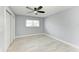Spacious bedroom with tiled floor, ceiling fan, neutral wall color, and a window overlooking the outdoors at 1364 Westport Ln # 1403, Sarasota, FL 34232