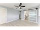 Well-lit bedroom with barn door leading to en suite bathroom, plus a modern ceiling fan for added comfort at 1364 Westport Ln # 1403, Sarasota, FL 34232